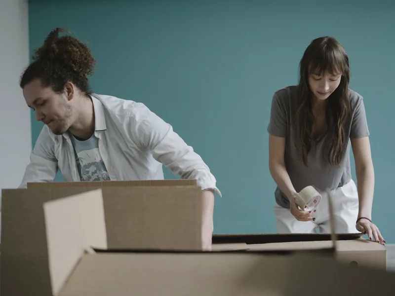 A man opening a moving box